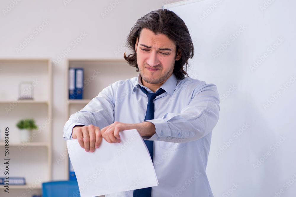 Young man employee in business presentation concept Young man employee in business presentation concept