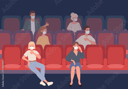 Young People sitting in the cinema in protective masks observe social distance