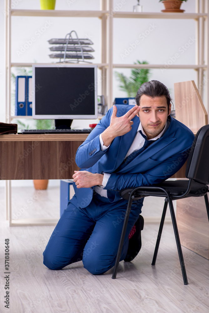 Young male employee businessman at workplace