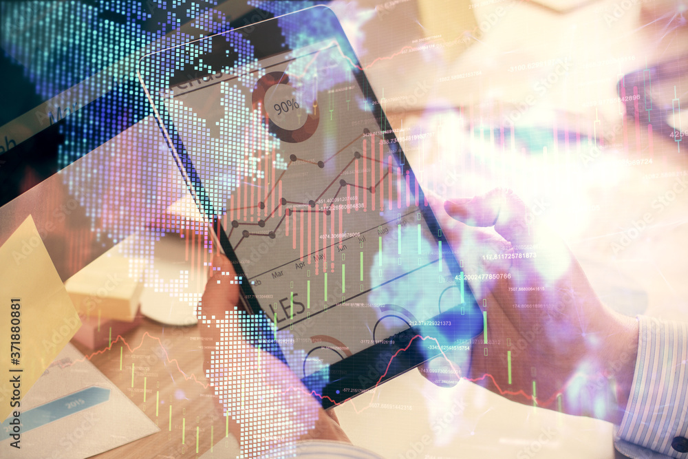Double exposure of man's hands holding and using a phone and financial graph drawing. Analysis concept. Double exposure of man's hands holding and using a phone and financial graph drawing. Analysis concept.