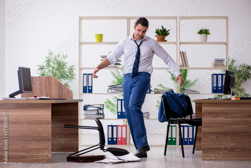 Young male employee businessman at workplace