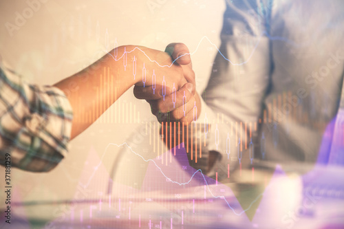 Double exposure of forex graph hologram and handshake of two men. Stock market concept.