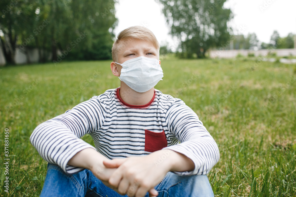 Boy in medical mask. Concept of quarantine and protection from polluted air. Coronavirus, illness, infection. Quarantine and protection virus, flu, epidemic COVID-19. Boy in medical mask. Concept of quarantine and protection from polluted air. Coronavirus, illness, infection. Quarantine and protection virus, flu, epidemic COVID-19.