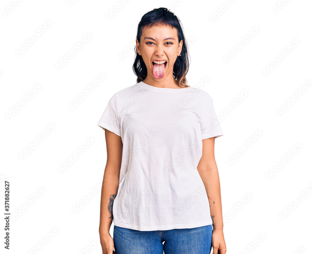 Young woman wearing casual clothes sticking tongue out happy with funny expression. emotion concept. Young woman wearing casual clothes sticking tongue out happy with funny expression. emotion concept.