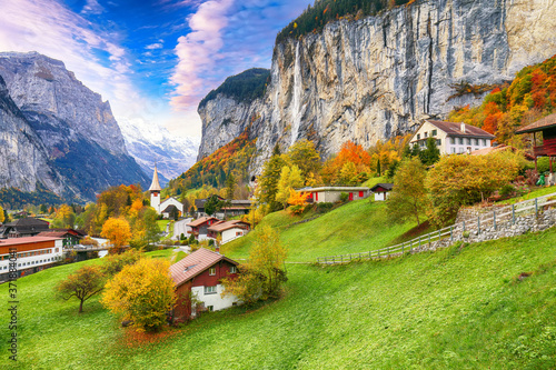 Astonishing autumn view of Lauterbrunnen valley with gorgeous Staubbach waterfall and Swiss Alps in the background.