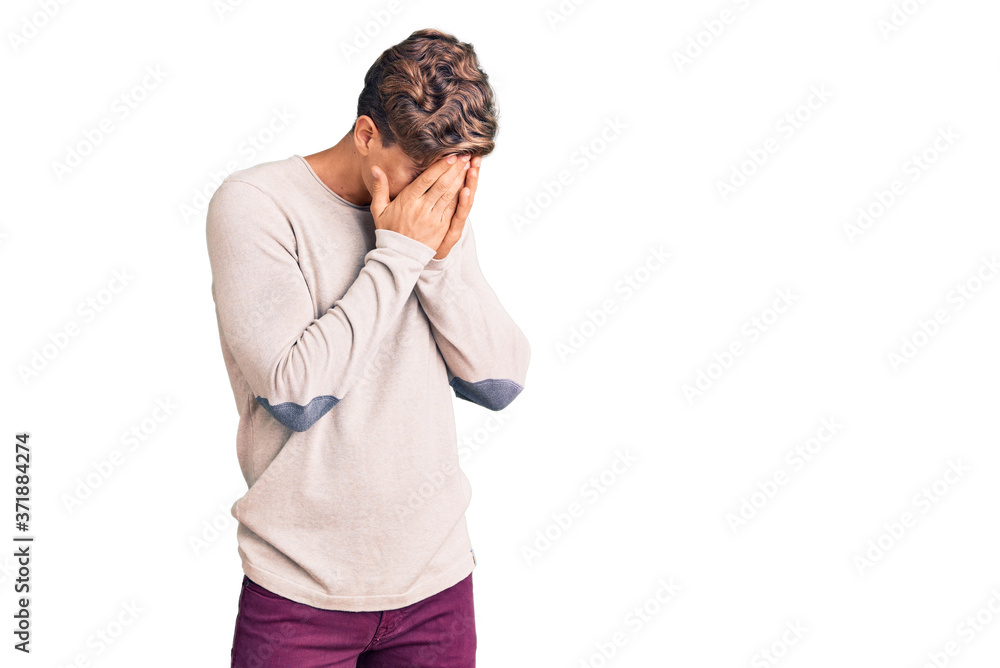 Young handsome man wearing casual clothes with sad expression covering face with hands while crying. depression concept.