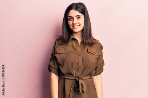 Young beautiful girl wearing casual dress with a happy and cool smile on face. lucky person.