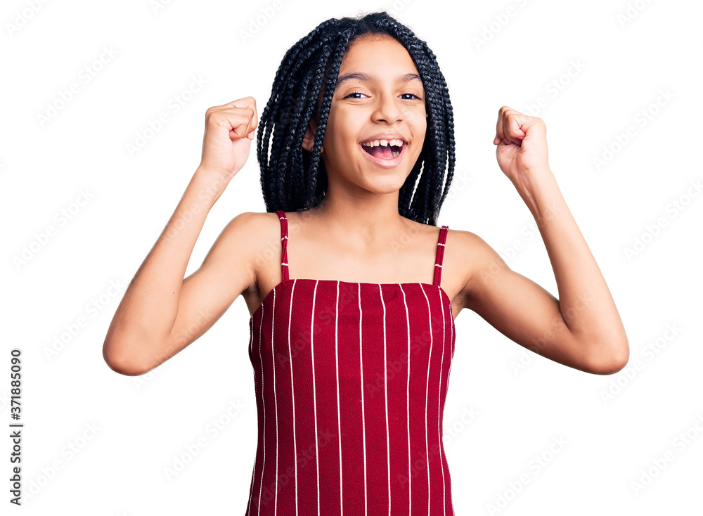 Fototapeta premium Cute african american girl wearing casual clothes screaming proud, celebrating victory and success very excited with raised arms