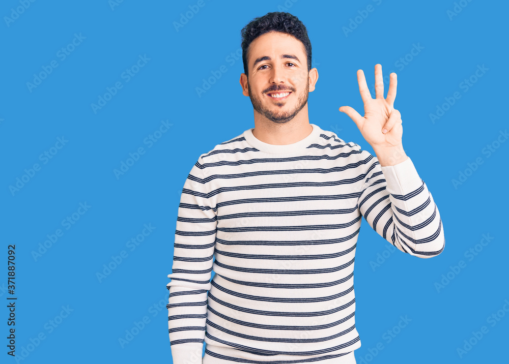 Young hispanic man wearing casual clothes showing and pointing up with fingers number four while smiling confident and happy. Young hispanic man wearing casual clothes showing and pointing up with fingers number four while smiling confident and happy.