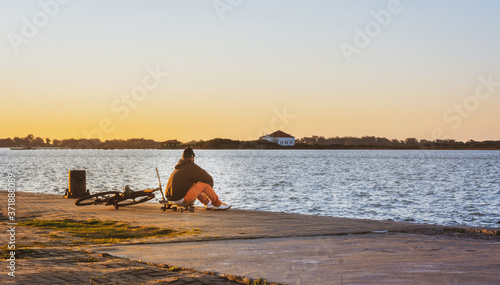 Man enjoying the sunset on the docks in southern Brazil