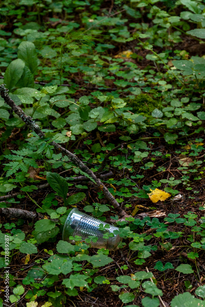 plastic cups and garbage on green grass, environmental pollution plastic cups and garbage on green grass, environmental pollution