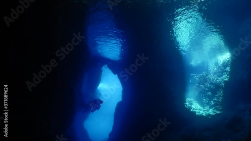 Wallpaper Mural cave diving underwater scuba divers exploring caves ocean scenery sun beams and rays background Torontodigital.ca