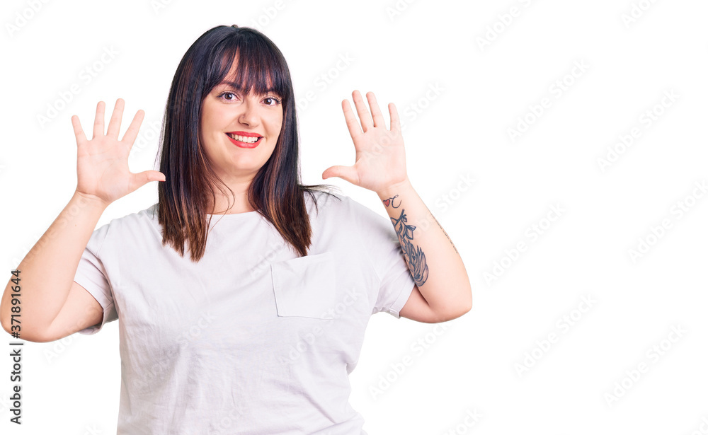 Young plus size woman wearing casual clothes showing and pointing up with fingers number ten while smiling confident and happy. Young plus size woman wearing casual clothes showing and pointing up with fingers number ten while smiling confident and happy.