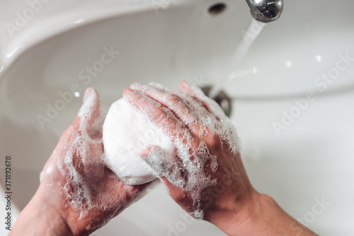 Man washing hands to protect against the coronavirus