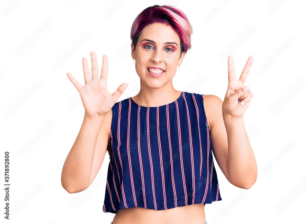 Young beautiful woman with pink hair wearing casual clothes showing and pointing up with fingers number seven while smiling confident and happy. Young beautiful woman with pink hair wearing casual clothes showing and pointing up with fingers number seven while smiling confident and happy.