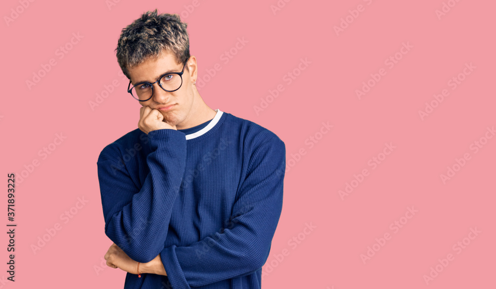 Fototapeta premium Young handsome man wearing casual clothes and glasses thinking looking tired and bored with depression problems with crossed arms.