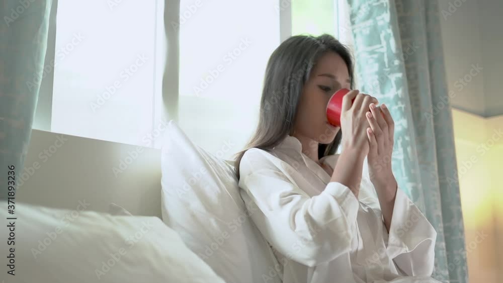 Slow motion clips,Beautiful woman drinking coffee in bed in the morning. Slow motion clips,Beautiful woman drinking coffee in bed in the morning.