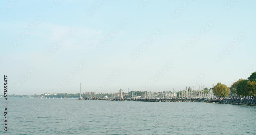 boats entering marina by the Lighthouse of Desenzano del Garda boats entering marina by the Lighthouse of Desenzano del Garda