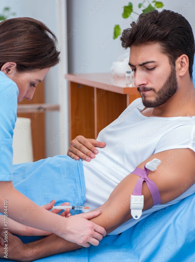 Woman doctor examining male patient in hospital Woman doctor examining male patient in hospital