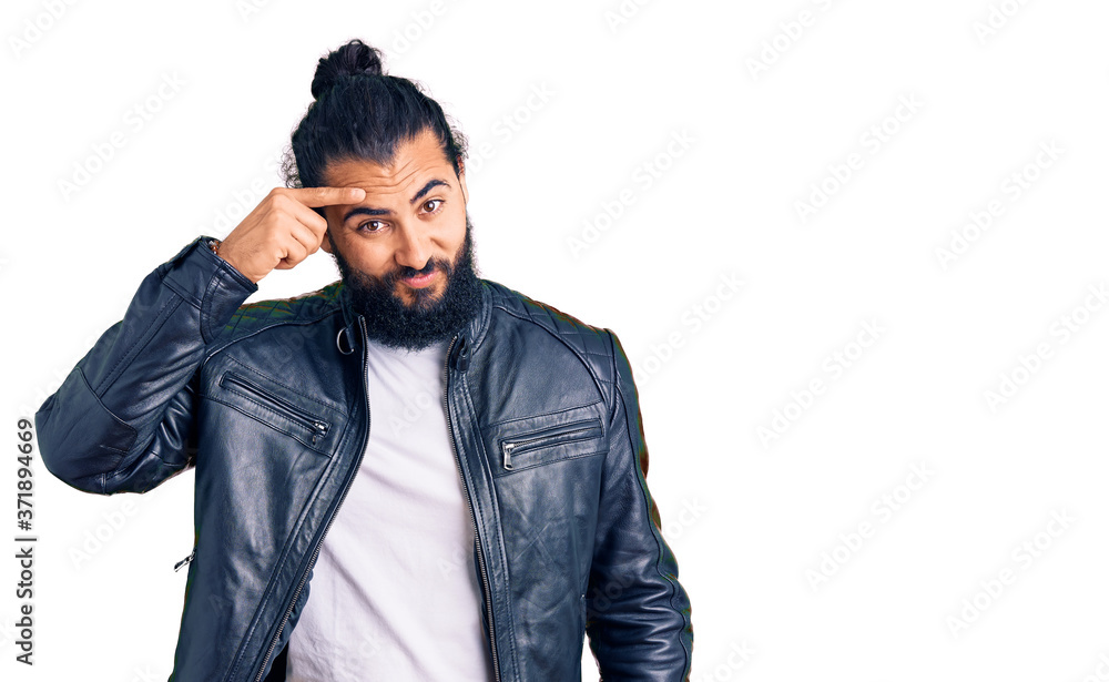 Young arab man wearing casual leather jacket pointing unhappy to pimple on forehead, ugly infection of blackhead. acne and skin problem Young arab man wearing casual leather jacket pointing unhappy to pimple on forehead, ugly infection of blackhead. acne and skin problem