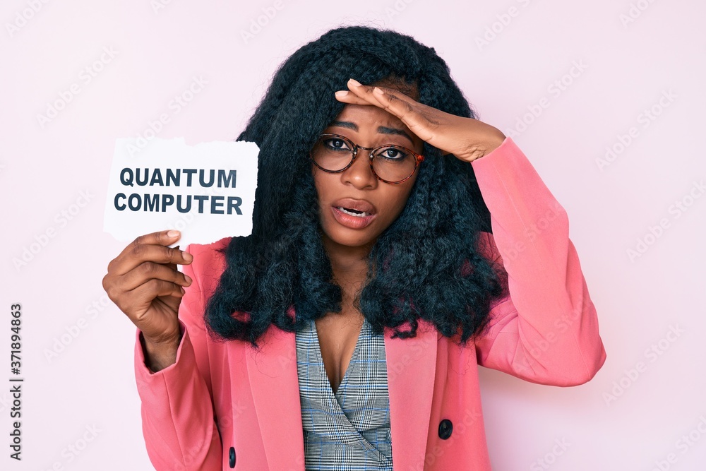 Beautiful african woman holding quantum computer banner stressed and frustrated with hand on head, surprised and angry face Beautiful african woman holding quantum computer banner stressed and frustrated with hand on head, surprised and angry face