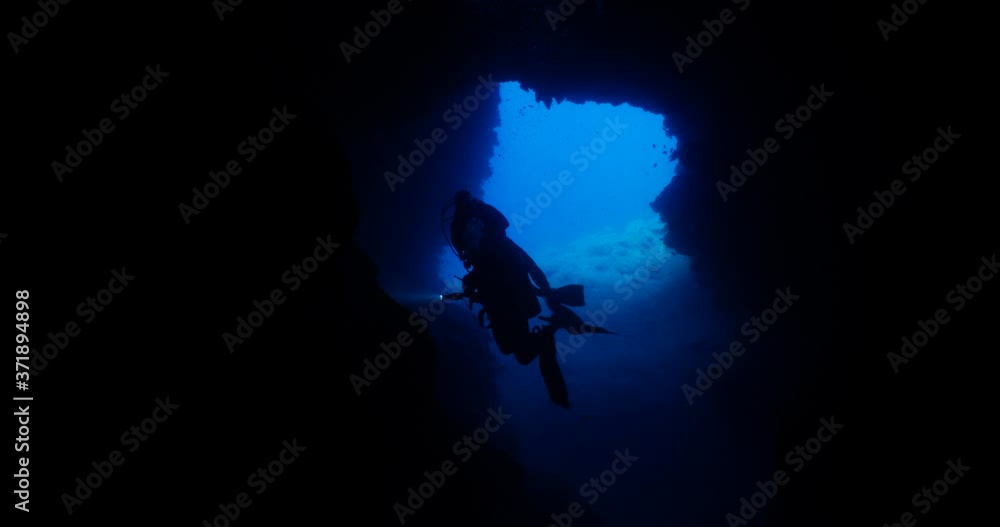 cave diving underwater scuba divers exploring caves ocean scenery sun beams and rays background cave diving underwater scuba divers exploring caves ocean scenery sun beams and rays background
