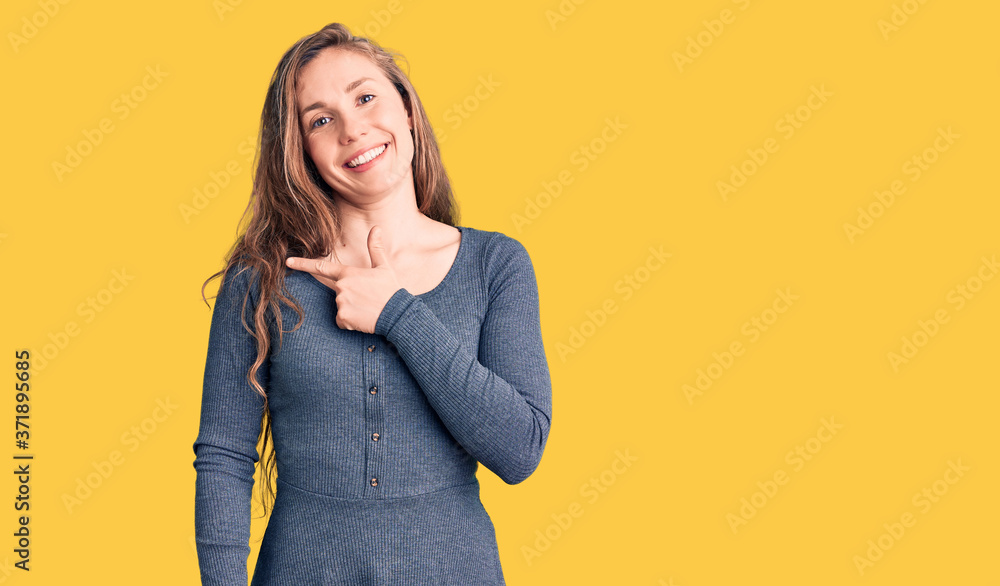 Young beautiful blonde woman wearing casual dress cheerful with a smile of face pointing with hand and finger up to the side with happy and natural expression on face Young beautiful blonde woman wearing casual dress cheerful with a smile of face pointing with hand and finger up to the side with happy and natural expression on face