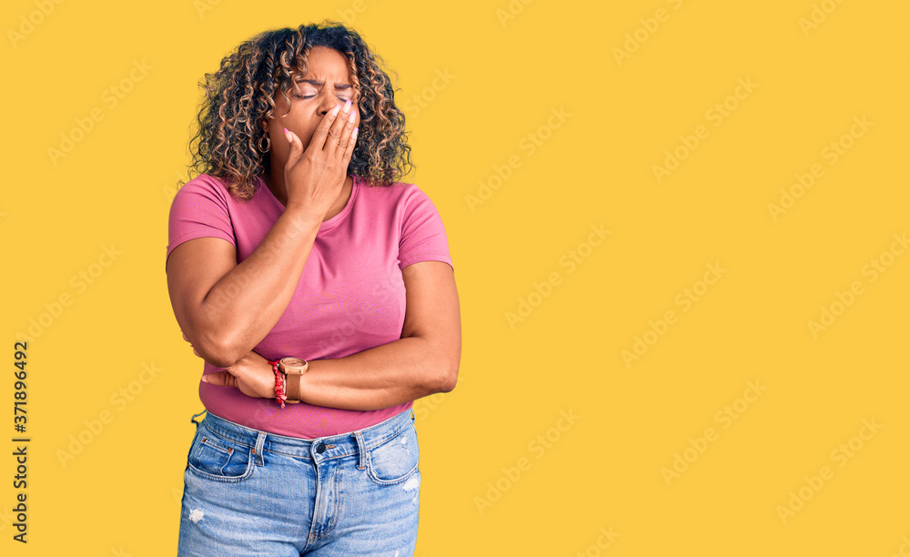 Young african american plus size woman wearing casual clothes bored yawning tired covering mouth with hand. restless and sleepiness. Young african american plus size woman wearing casual clothes bored yawning tired covering mouth with hand. restless and sleepiness.