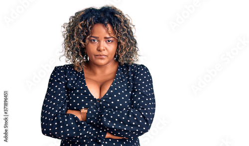 Young african american plus size woman wearing casual clothes skeptic and nervous, disapproving expression on face with crossed arms. negative person.