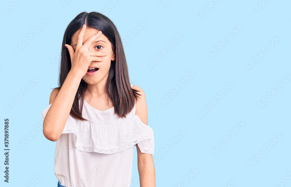 Beautiful child girl wearing casual clothes peeking in shock covering face and eyes with hand, looking through fingers with embarrassed expression. Beautiful child girl wearing casual clothes peeking in shock covering face and eyes with hand, looking through fingers with embarrassed expression.
