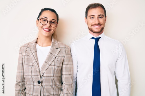 Fotografie Beautiful couple wearing business clothes with a happy and cool smile on face