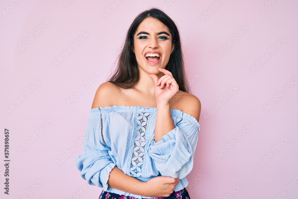 Brunette teenager girl wearing casual clothes smiling looking confident at the camera with crossed arms and hand on chin. thinking positive. Brunette teenager girl wearing casual clothes smiling looking confident at the camera with crossed arms and hand on chin. thinking positive.