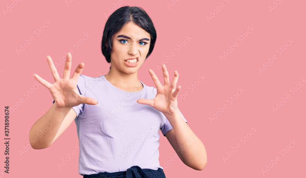 Brunette teenager girl wearing casual clothes afraid and terrified with fear expression stop gesture with hands, shouting in shock. panic concept. Brunette teenager girl wearing casual clothes afraid and terrified with fear expression stop gesture with hands, shouting in shock. panic concept.