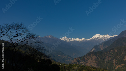 A panoramic view of Mt Kanchenjunga with first rays of sunlight falling on it 