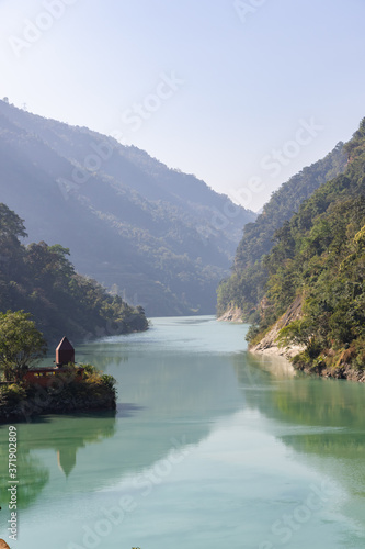 Teesta river flowing down from Sikkim to Darjeeling district with lush green hills and mountains on both sides