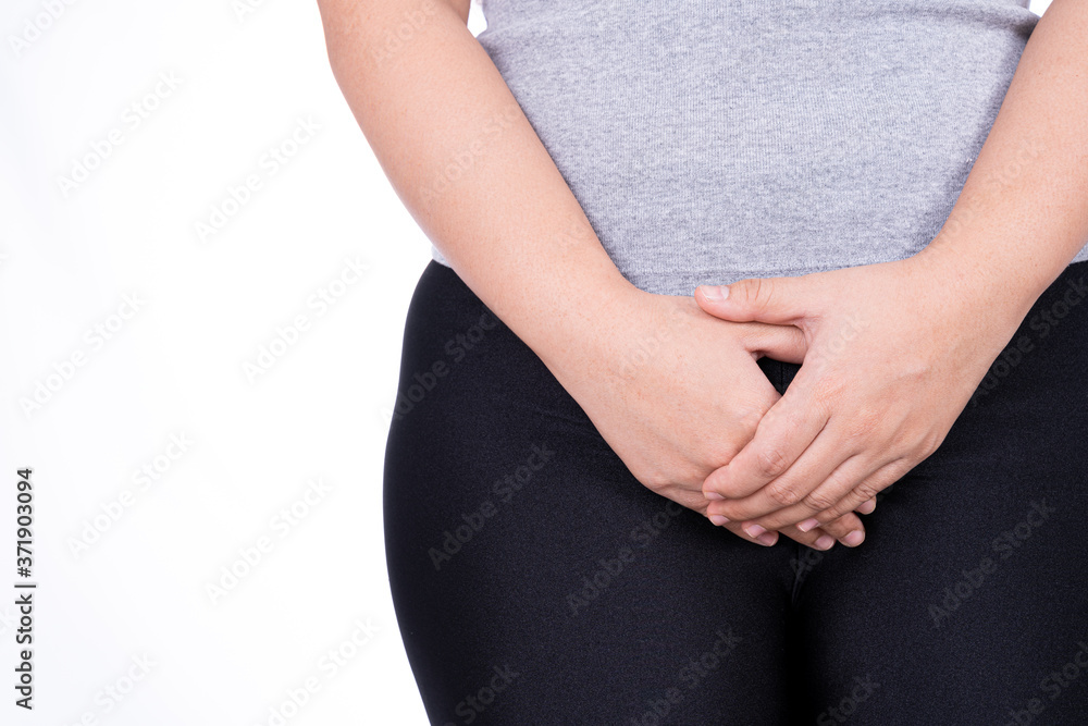 Woman hands holding her crotch suffering from painful stomachache on white background. Medical, healthcare for advertising concept. Woman hands holding her crotch suffering from painful stomachache on white background. Medical, healthcare for advertising concept.
