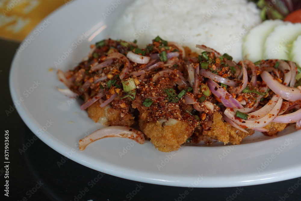 Cooked fried chicken, spicy seasoning with rice. Cooked fried chicken, spicy seasoning with rice.