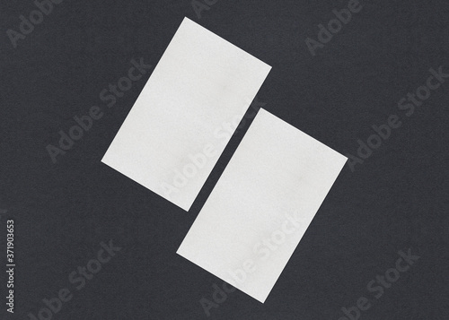 Blank white Business card mockup stacks on grey textured paper background. © shaadjutt36