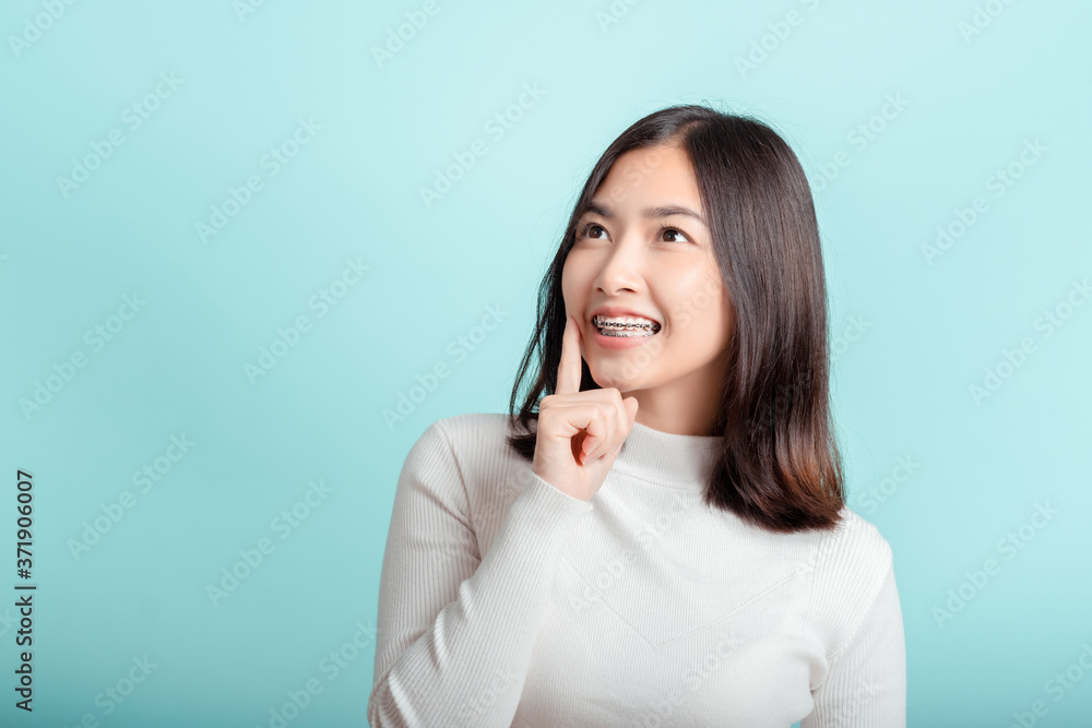 Dental braces of young asian woman wearing braces with white teeth concept. Dental braces of young asian woman wearing braces with white teeth concept.