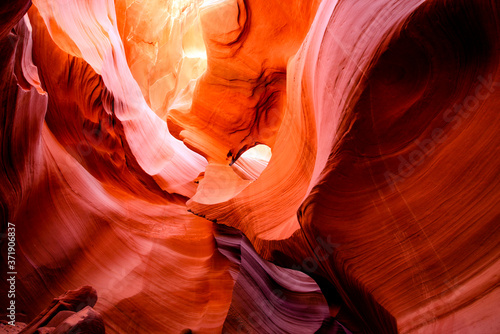 The mysterious Lower Antelope Canyon in Page Arizona with natural landscapes of bright sandstones stacked in flaky fire waves in a narrow sandy labyrinth