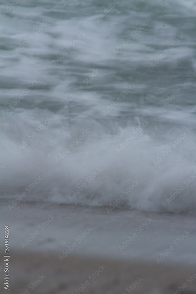 Long exposure photo of a wave breaking. Long exposure photo of a wave breaking.