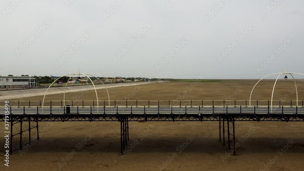 Quiet pier at seaside resort, aerial slow pan right Quiet pier at seaside resort, aerial slow pan right