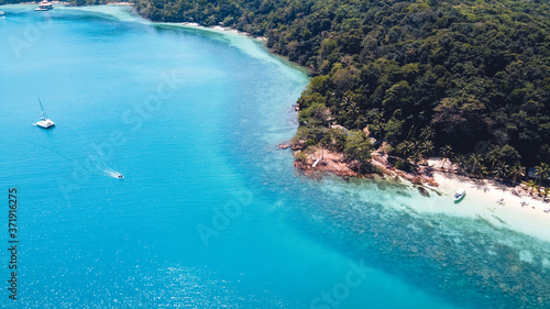 Clear water on the island,Bright blue sea and wooden boat The tourism © artrachen