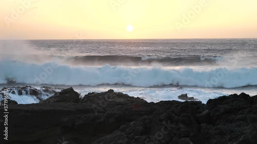 Beautiful Golden Hour Sunset With Giant Waves Roll and Crash Onto Rocks (1 of 3) photo