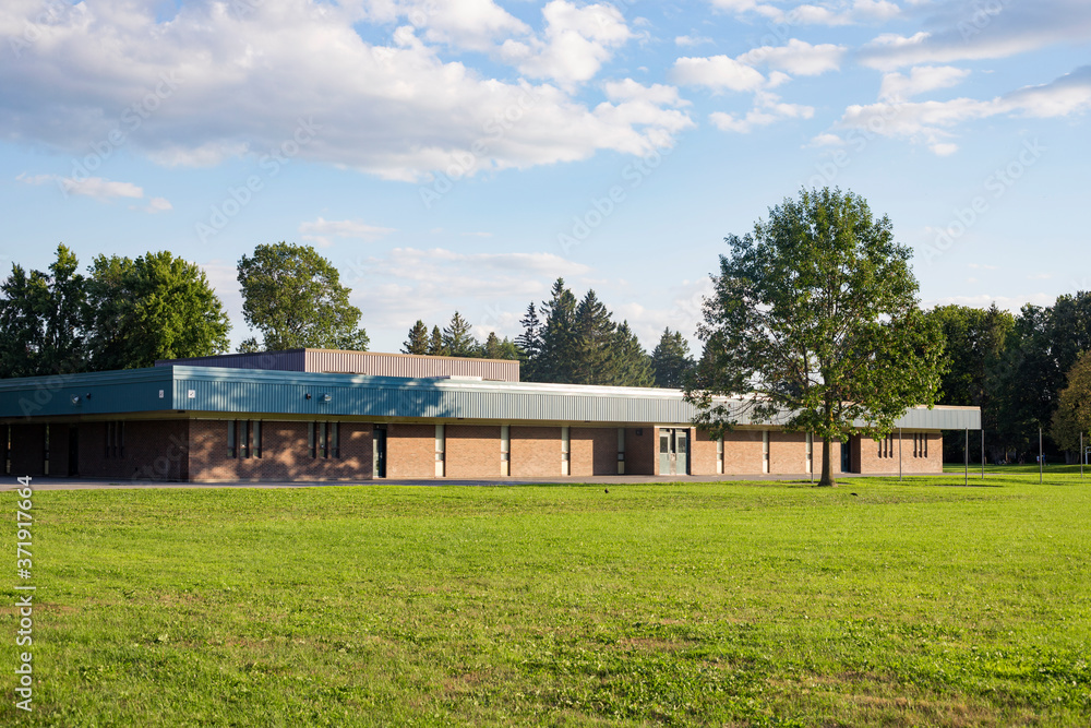 School building and schoolyard with field