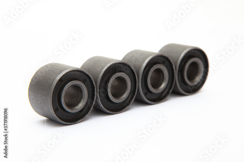 close up of a black and silver rubber bushing ring in white background
