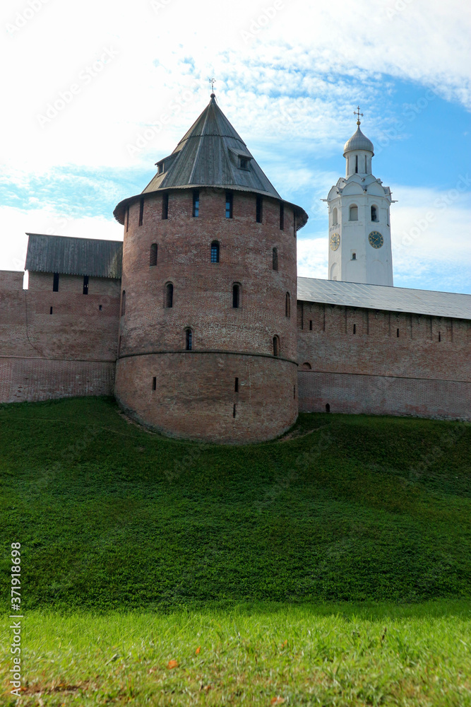 View to Metropolitan tower and wall of the Velikiy (Great) Novgorod citadel (kremlin, detinets) in Russia under blue summer sky in the morning