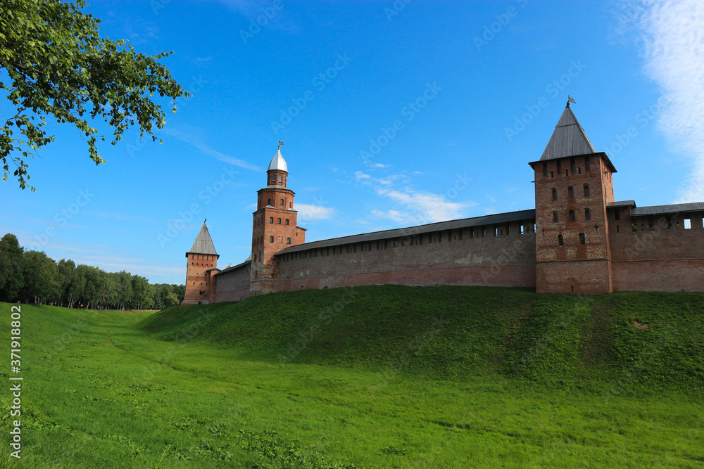 View to the wall and towers of the Velikiy (Great) Novgorod citadel (kremlin, detinets) in Russia under blue summer sky in the morning 