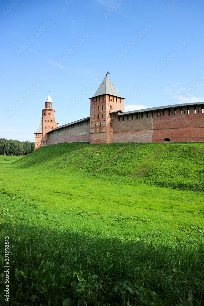 View to the wall and towers of the Velikiy (Great) Novgorod citadel (kremlin, detinets) in Russia under blue summer sky in the morning 