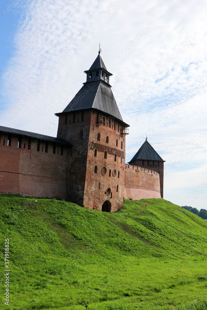 Spasskaya Tower at south side of the wall of the Velikiy (Great) Novgorod citadel (kremlin, detinets) in Russia under blue summer sky in the morning 